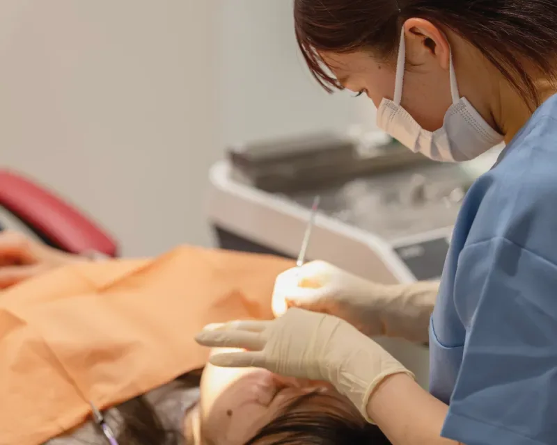 患者様の口元を処置する歯科衛生士